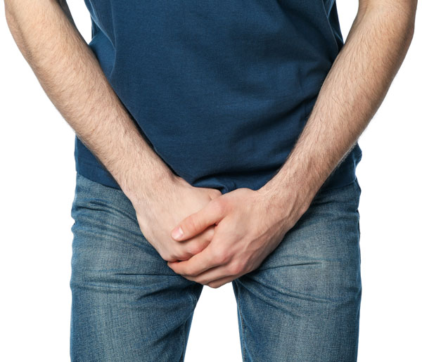 man-holding-his-groin-isolated